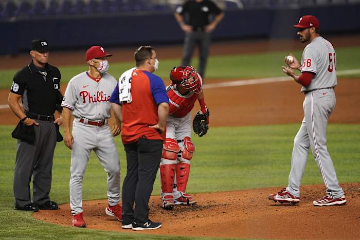 Zach Eflin is visited on the mound by medical trainer Paul Buchheit in Miami